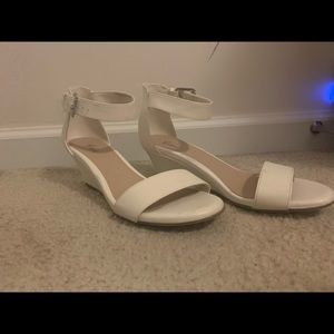 Women’s low wedged white shoes.